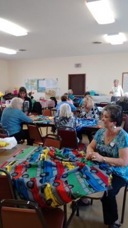 members tying blankets